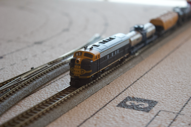 Work on Scenic Ridge, my N-Scale layout. Pictured is a n-scale F-7 diesel locomotive bearing the Santa Fe Railroad logo.