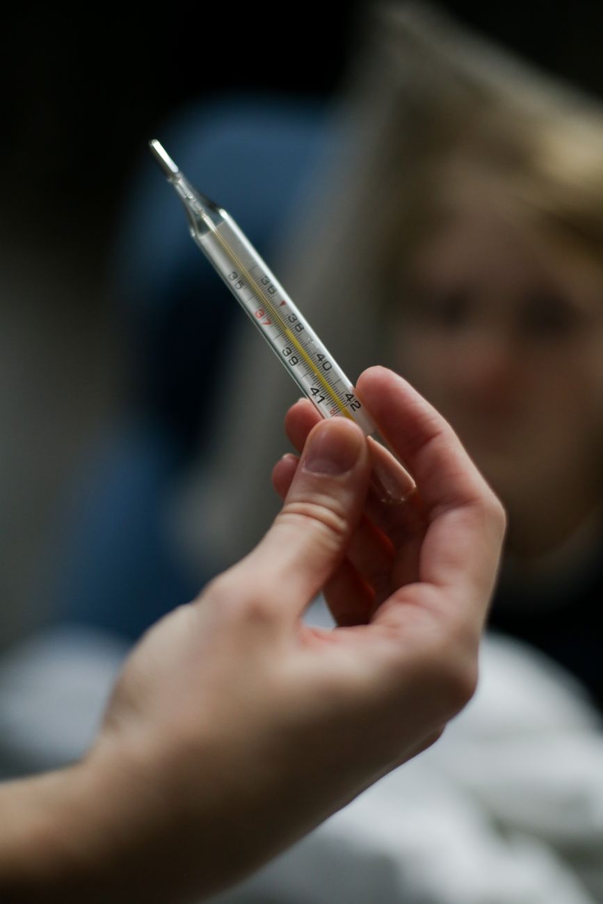 a person holding a thermometer